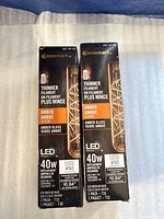Front view of both boxed bulbs showing brand, specs and quantity