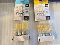 Two opened 4-pack boxes with bulbs seated in cardboard holders