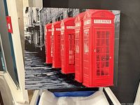 Front view of canvas print showing red telephone booths and street scene