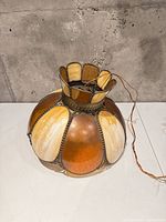 Front view of stained glass pendant showing amber and cream panels