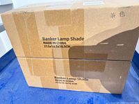 Two boxed banker lamp shades with dimensions printed