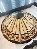 Overall view of stained glass shade showing colors, pattern and metal cap