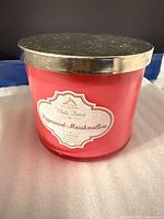 Front view of White Barn Peppermint Marshmallow candle showing label, red-pink glass and silver lid