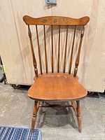 Front view showing spindle back, seat, turned legs