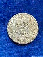 Reverse of 1958 Canada silver dollar showing totem pole design