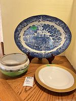 All three porcelain pieces displayed on table