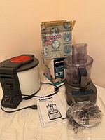 All four appliance units visible: food processor assembled, Proctor steamer, Kenwood mincer box, accessories and manual