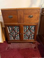 Full view of console cabinet front showing upper drawers, lower doors with lattice and fabric curtains