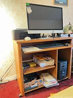 Front view showing monitor and shelves on oak laminate desk