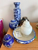 Group shot of all six porcelain pieces on shelf