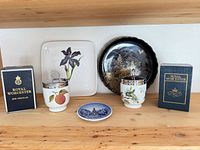 Group shot showing two Royal Worcester egg coddlers with boxes, Watercolors iris plate, Shibata Tenmoku-Kiku plate, and souvenir plate