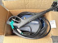 Pressure washer main unit with hose and spray gun inside box