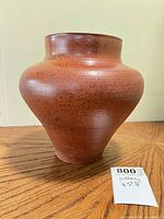 Front view of speckled terracotta stoneware vase displaying bulbous form and height scale
