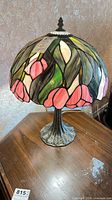 Full view of lamp on table showing shade design and base