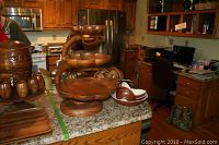 Wide shot of kitchen counter showing lazy Susan snack tray, salad bowl, small bowls, soup bowls, and utensils.