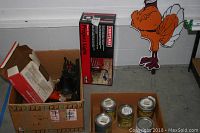 Photo showing boxed Craftsman Project Light, four paint cans, and box with jumper cables.
