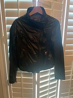 Front view showing asymmetrical zipper, pockets, collar detail