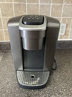 Front view of Keurig coffee maker showing drip tray and brew head