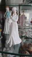 Front view of Royal Doulton Sentiments Noel figurine in cabinet