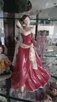 Full view of Royal Doulton figurine in red gown with cream sash
