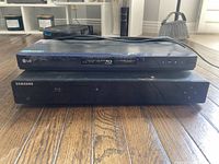 Samsung and LG Blu-ray players stacked, full view