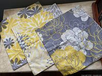 Three patterned pillow covers displayed front side showing floral and geometric prints