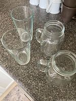 Top view of two mason jar mugs and two tall tumblers on countertop