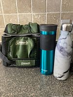 Coleman cooler, Contigo mug, S'well bottle standing together for scale and exterior view
