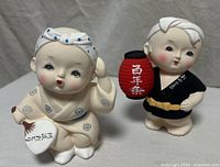 Both Hakata child figurines front view