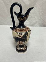 Full view of ewer-style vase showing handle, spout and painted scene