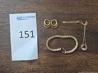Lot overview showing bracelet, hoop earrings, necklace with pendant