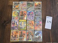 Overall view of 16 sleeved Pokémon cards laid out 4×4