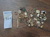 Overall view of entire mixed sterling silver jewelry lot on wood surface