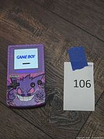 Front view of powered-on Nintendo Game Boy Color with Gengar shell