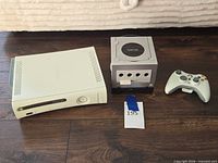Front view of Xbox 360 console, Nintendo GameCube console, Xbox 360 controller