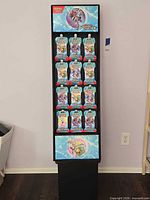 Full view of black retail display stand filled with booster packs