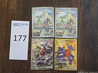 All four Pokémon TCG cards laid out in sleeves and top loaders