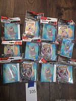 Top view of 12 sealed mini portfolios with booster packs