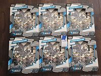 Six sealed Black Bolt Binder Collection boxes laid out