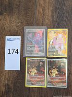 Four Pokémon cards in protectors: two Mewtwo ex, two Meowth