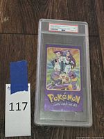 Full PSA-encased Team Rocket holo card with lot tag visible