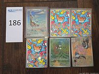 All six sleeved cards in two-column grid beside lot number card