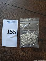 Sealed bag of sterling earring hooks and lot number