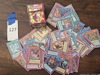 Pile of sleeved Yu-Gi-Oh! cards with Konami deck box visible