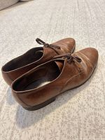 Left and right shoes side profile showing leather condition and heels