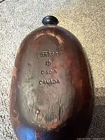 Underside of clay baker showing Cartier C-50-A Canada stamp