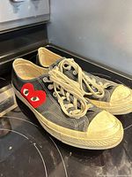 Left side view of both sneakers on stovetop