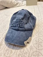 Front view showing embroidered logo and bottle opener on brim