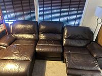 front view of three-seat leather sectional showing chaise, middle seat and recliner