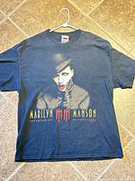 Full front view of T-shirt on hanger